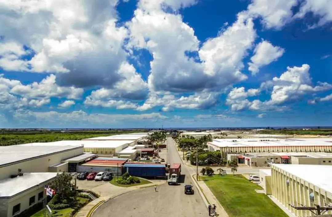 Aerial view of the buildings at the Las Américas Free Zone industrial park, with a container truck on the main road